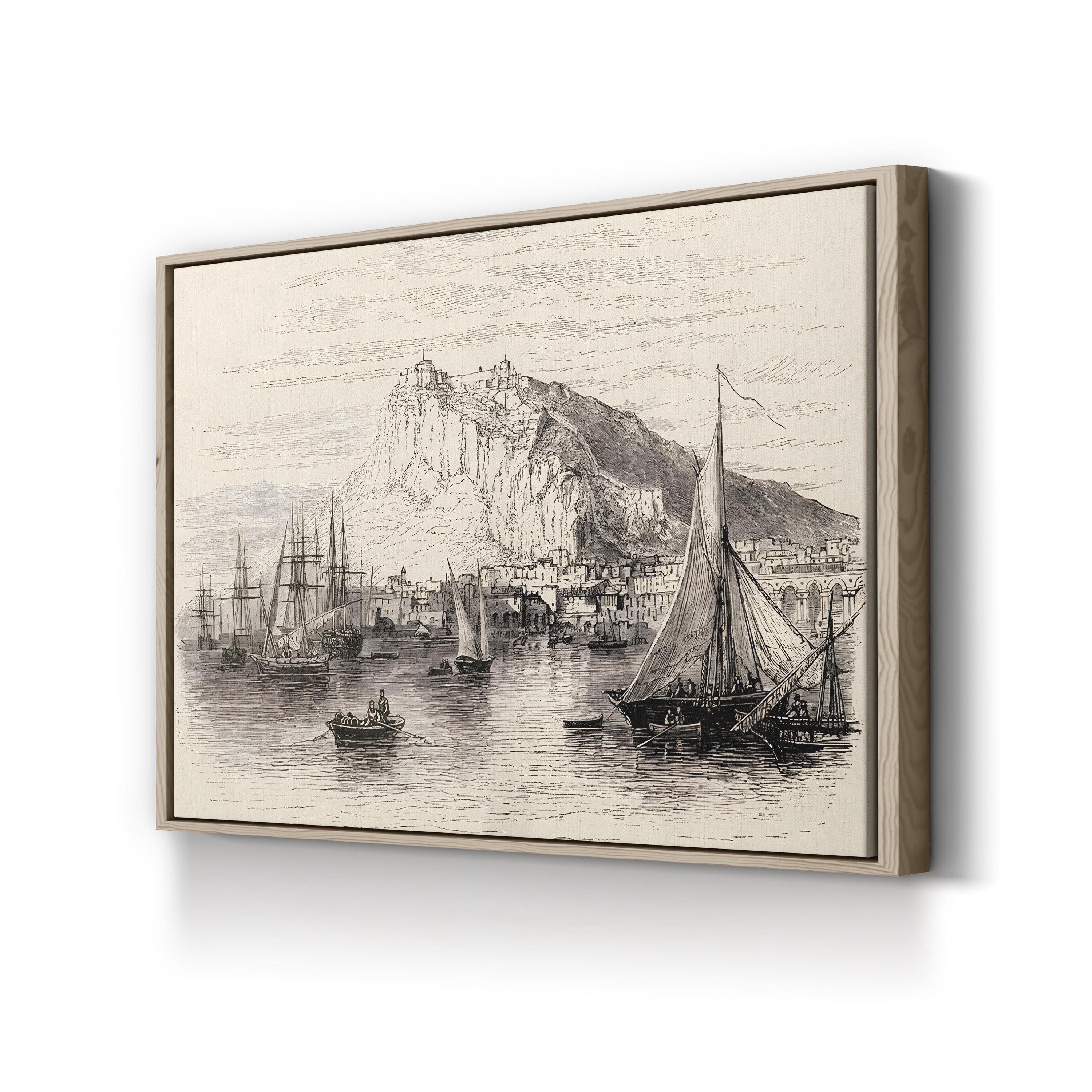 Framed artwork of a coastal scene with boats and a mountain on a white wall.