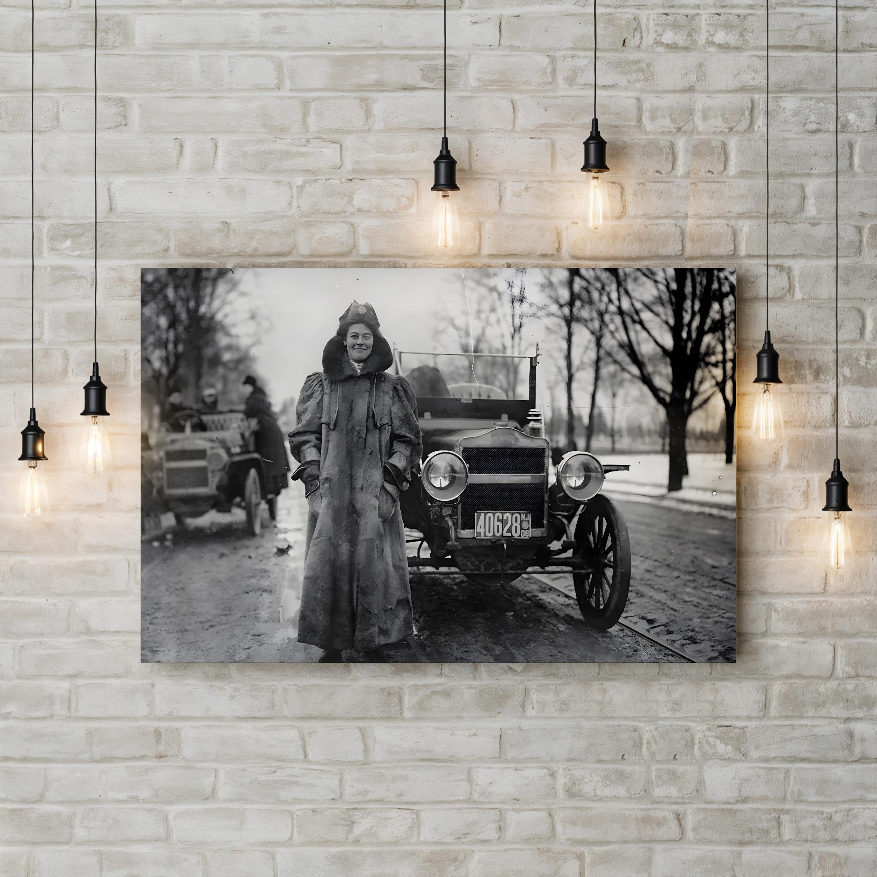 Vintage black and white photo of a woman standing next to an old car on a brick wall.