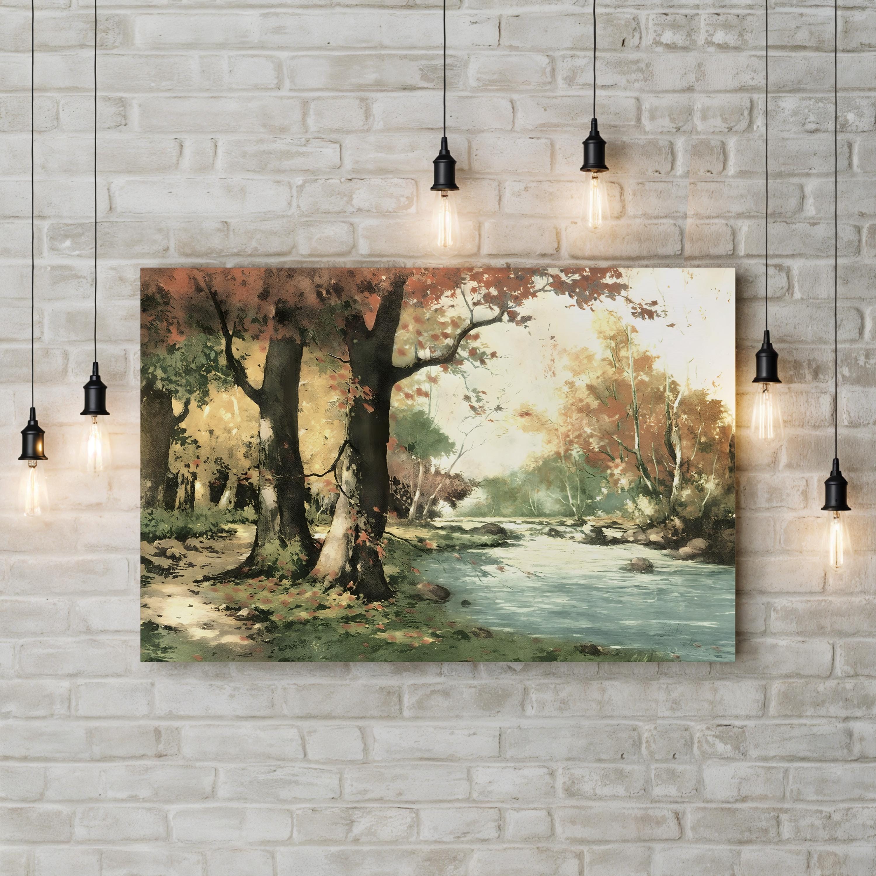 Framed landscape painting of a forest scene with a river on a brick wall.