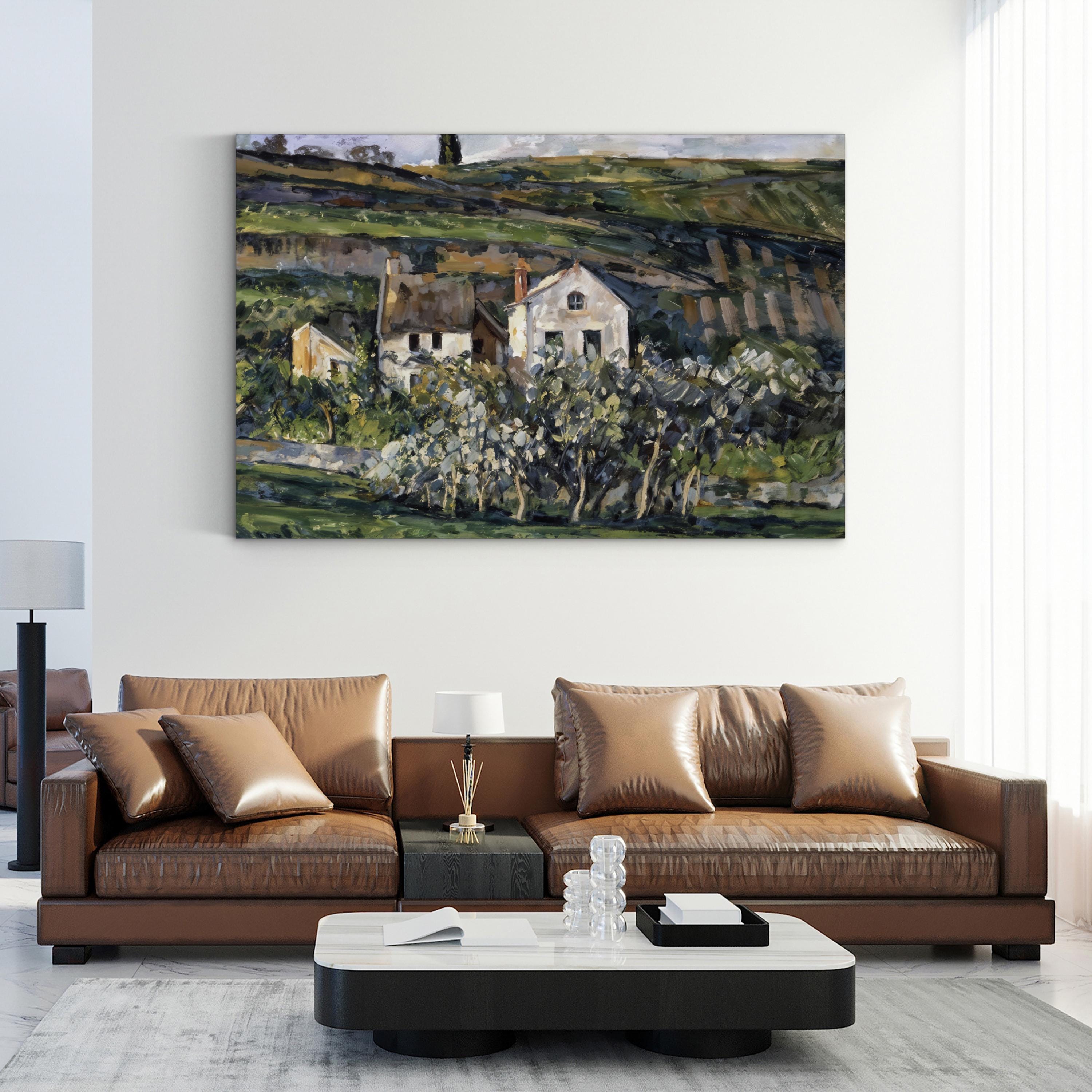 Modern living room with a brown leather sofa and a painting of a landscape on the wall.