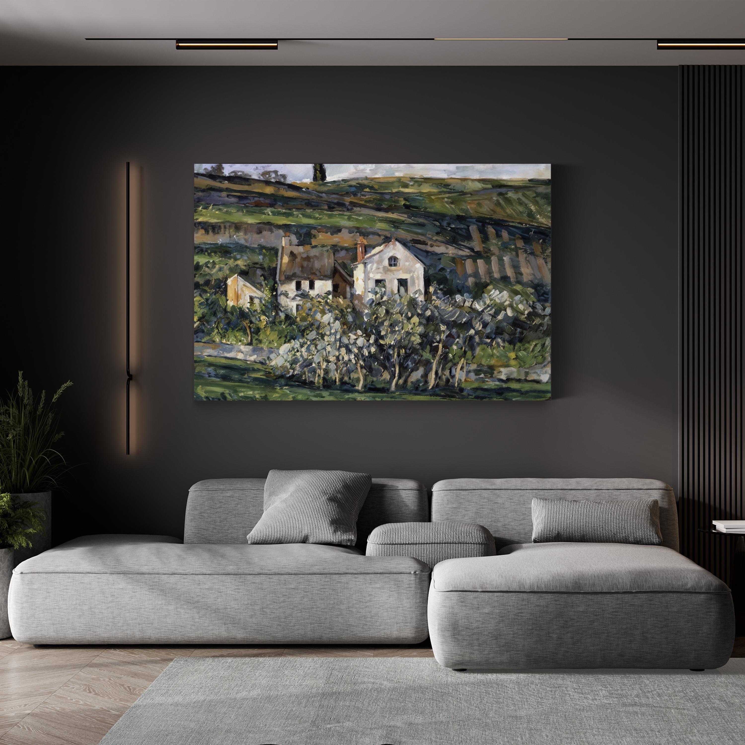 Gray sectional sofa in a living room with a painting of a landscape on the wall.