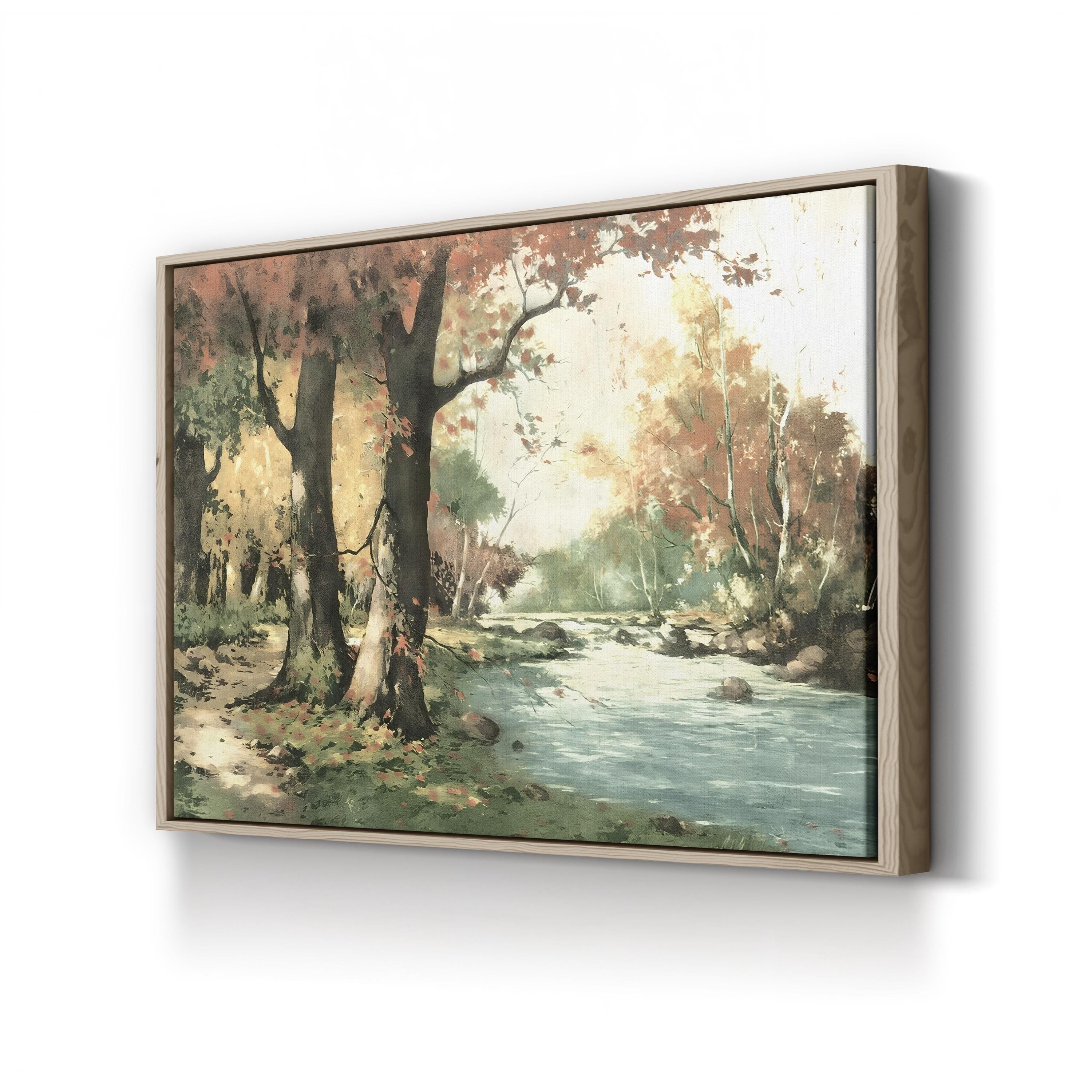 Framed artwork of a forest scene with a stream on a white wall