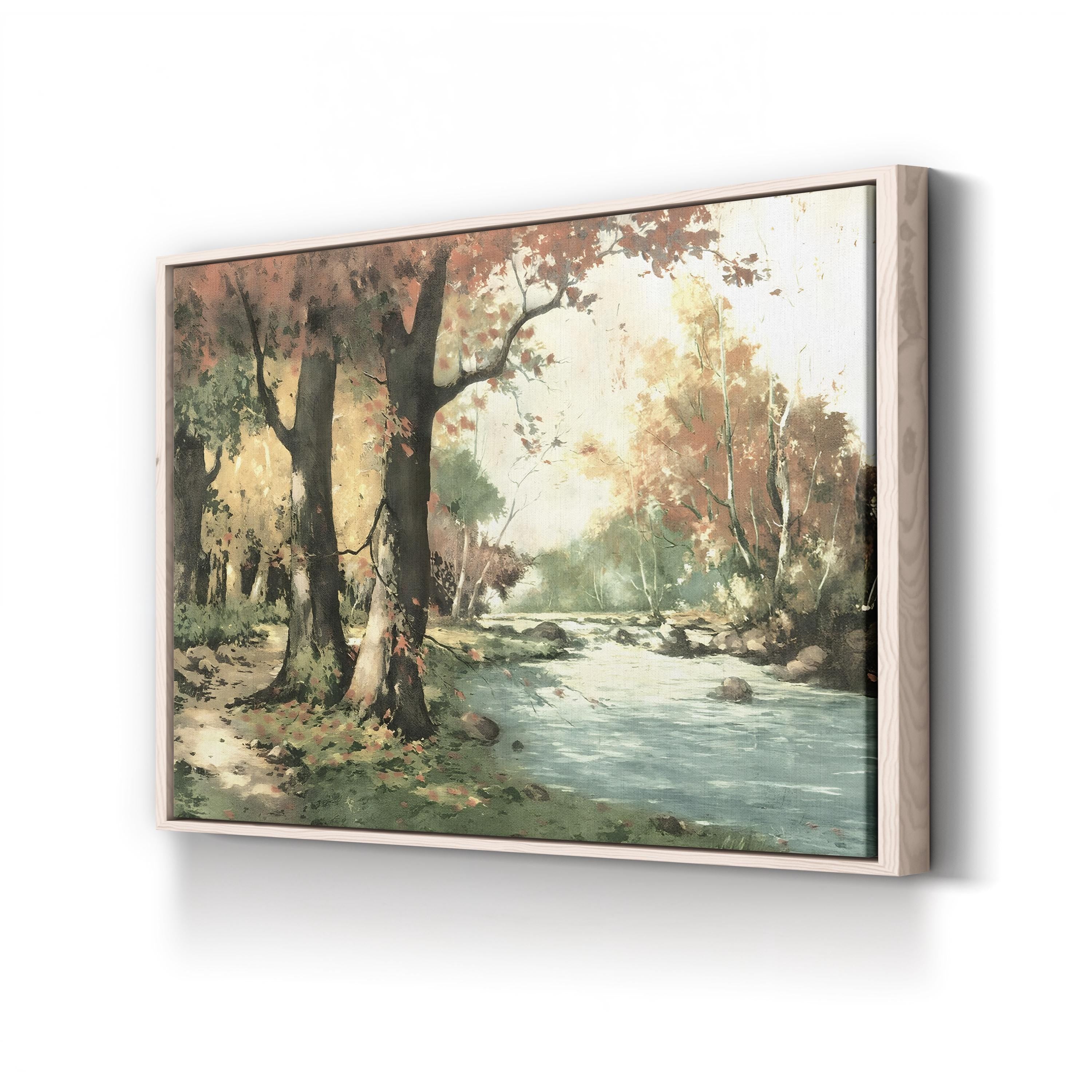 Framed artwork of a forest scene with a stream on a white wall