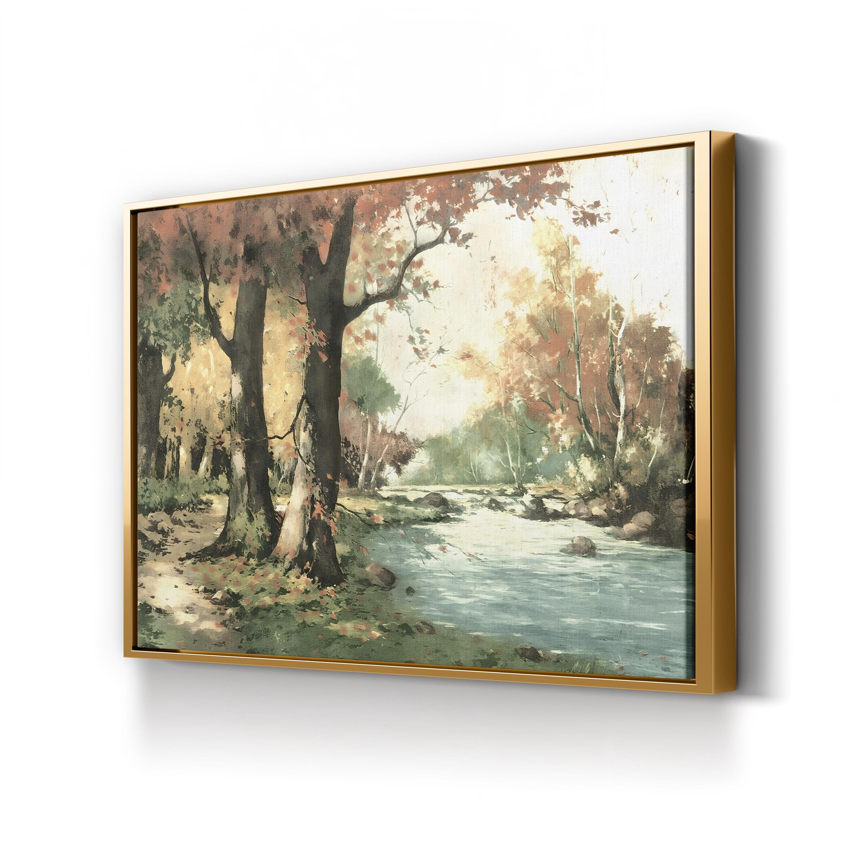 Framed painting of a forest scene with a stream on a white wall