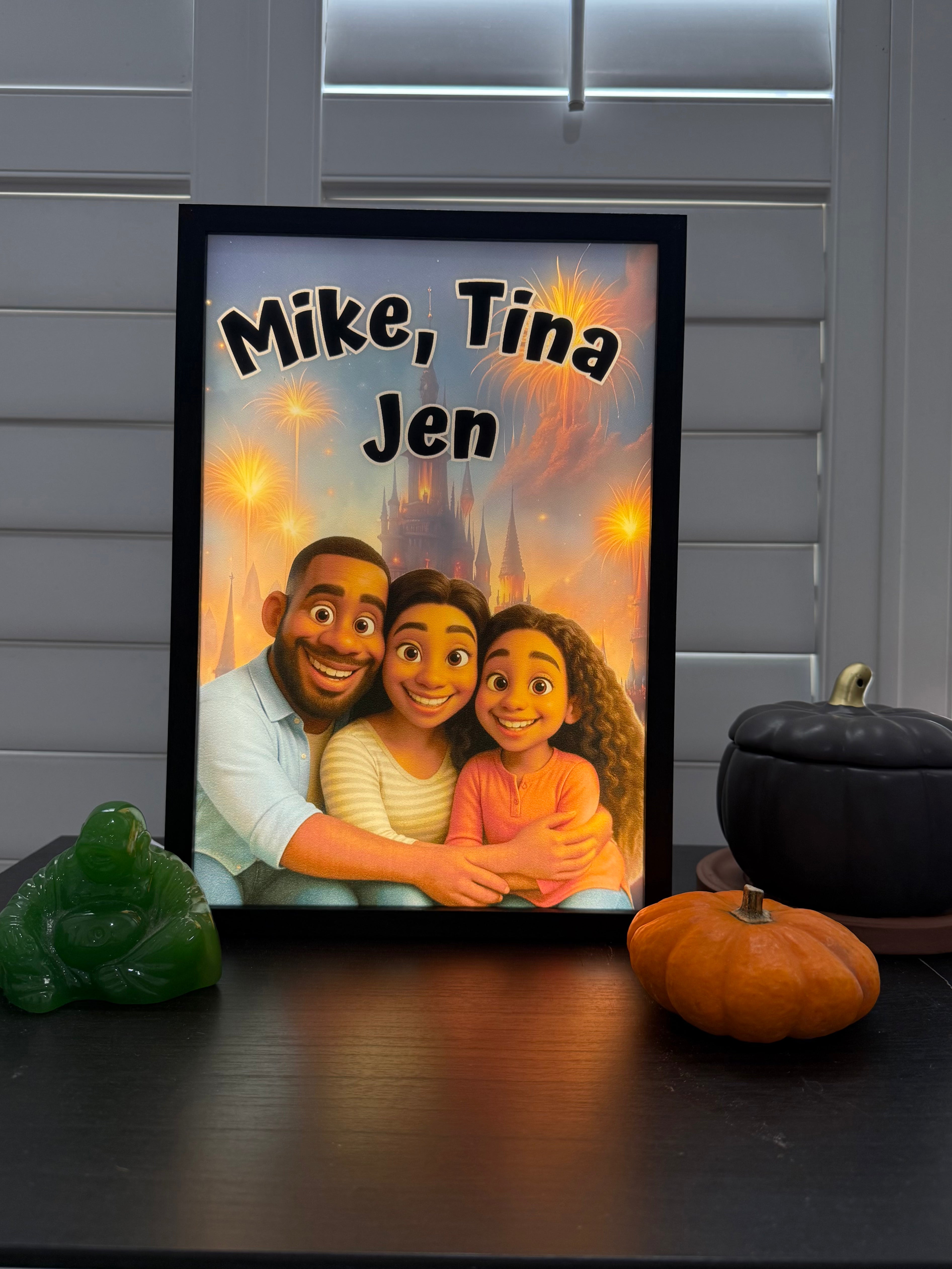 A framed custom family portrait print displayed on a dark tabletop. The artwork shows three people hugging in front of a glowing castle-like background with the text 'Mike, Tina Jen' at the top.