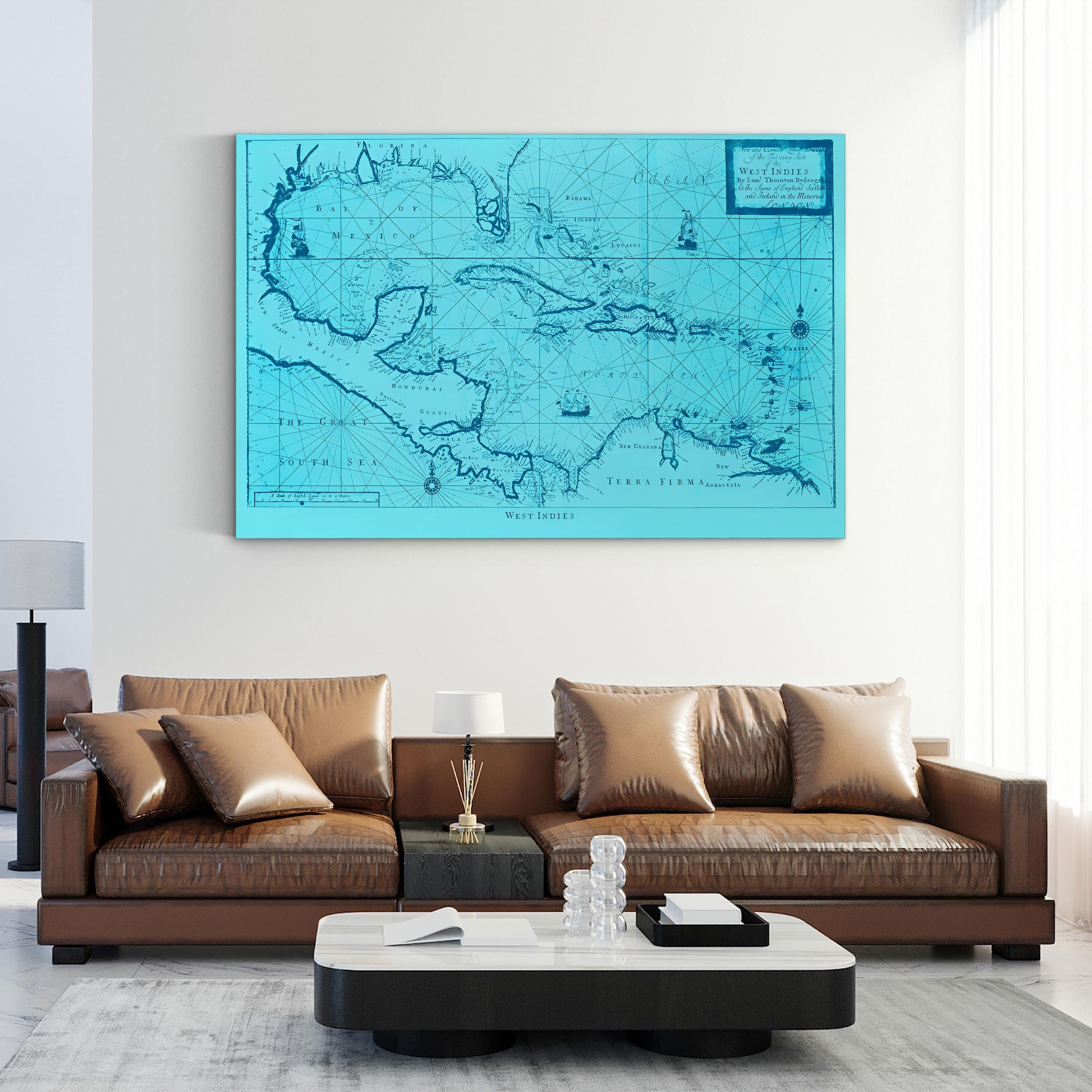 Turquoise map on a wall above a brown leather sofa in a living room.