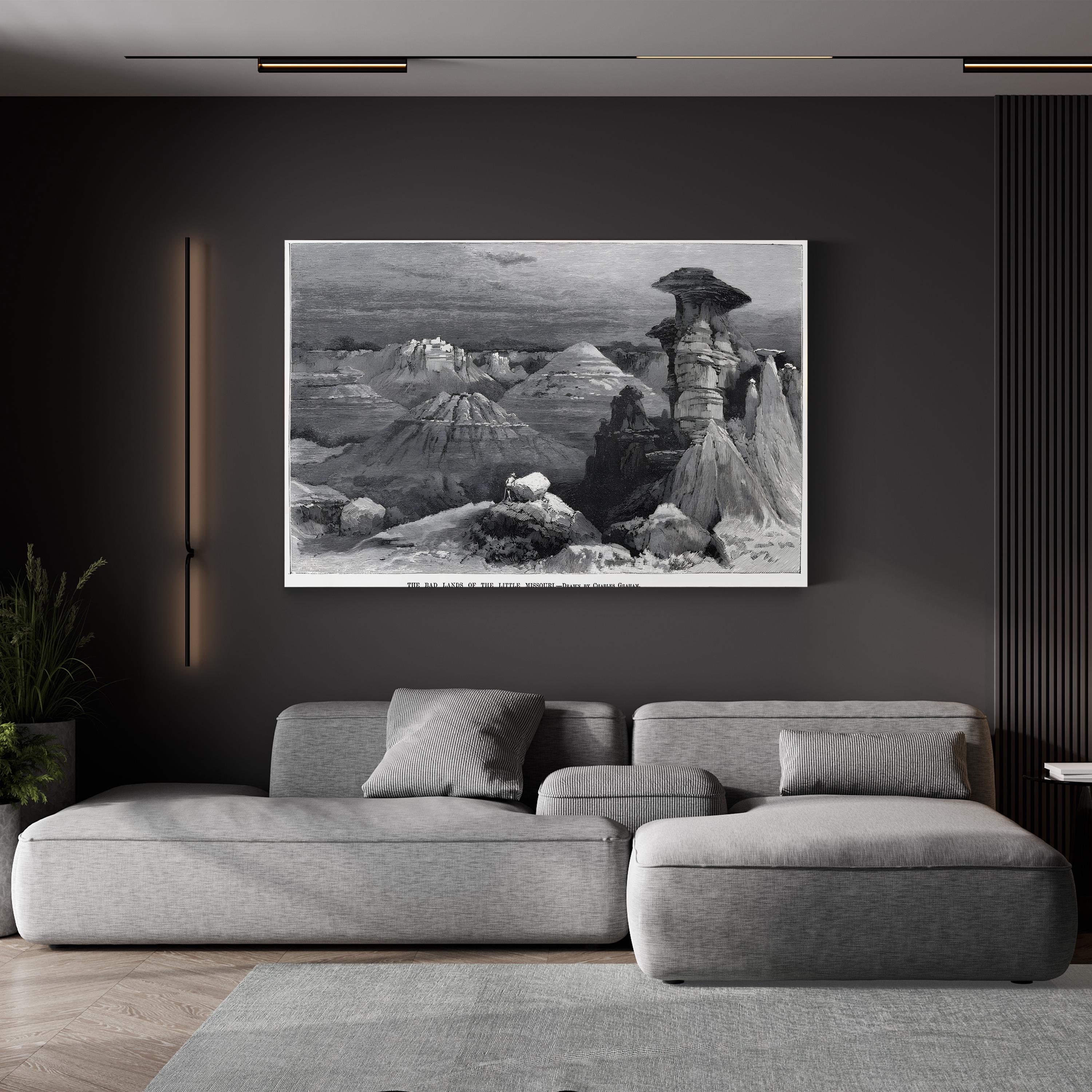 Gray sectional sofa in a living room with a large black and white landscape painting on the wall.