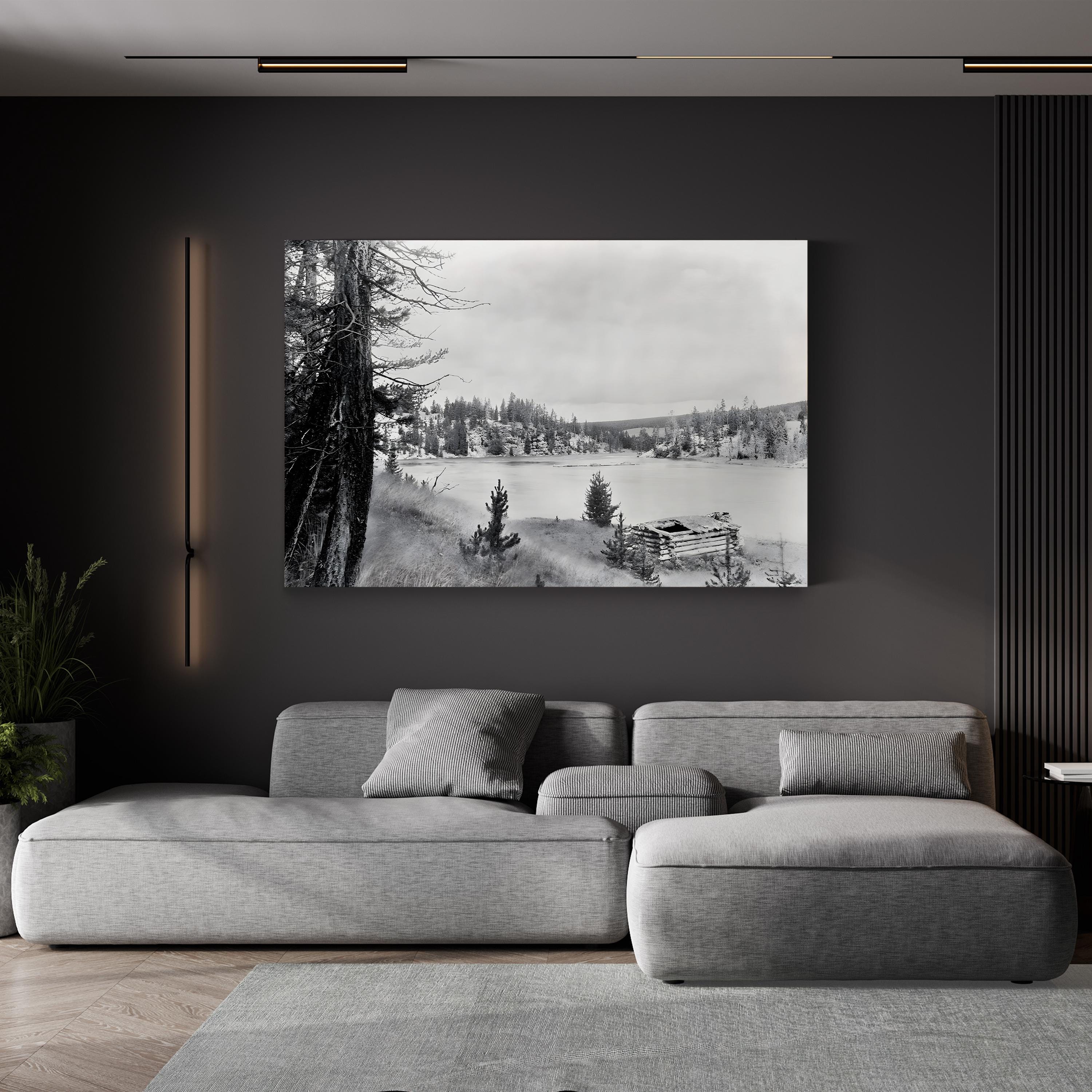 Yellowstone River Cabin, 1913 canvas print in a black frame displayed above a gray sofa