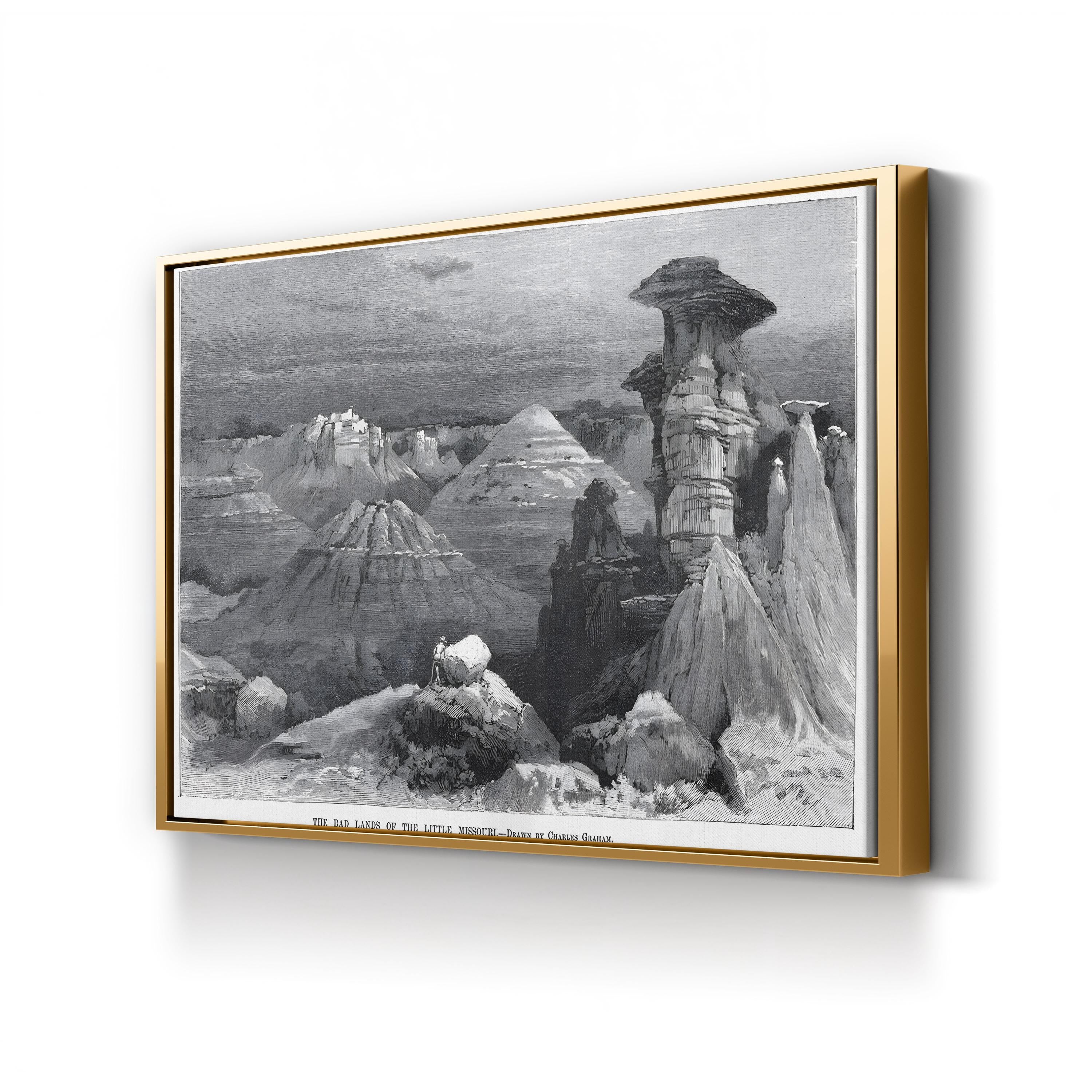 Framed black and white landscape print of a canyon on a white wall