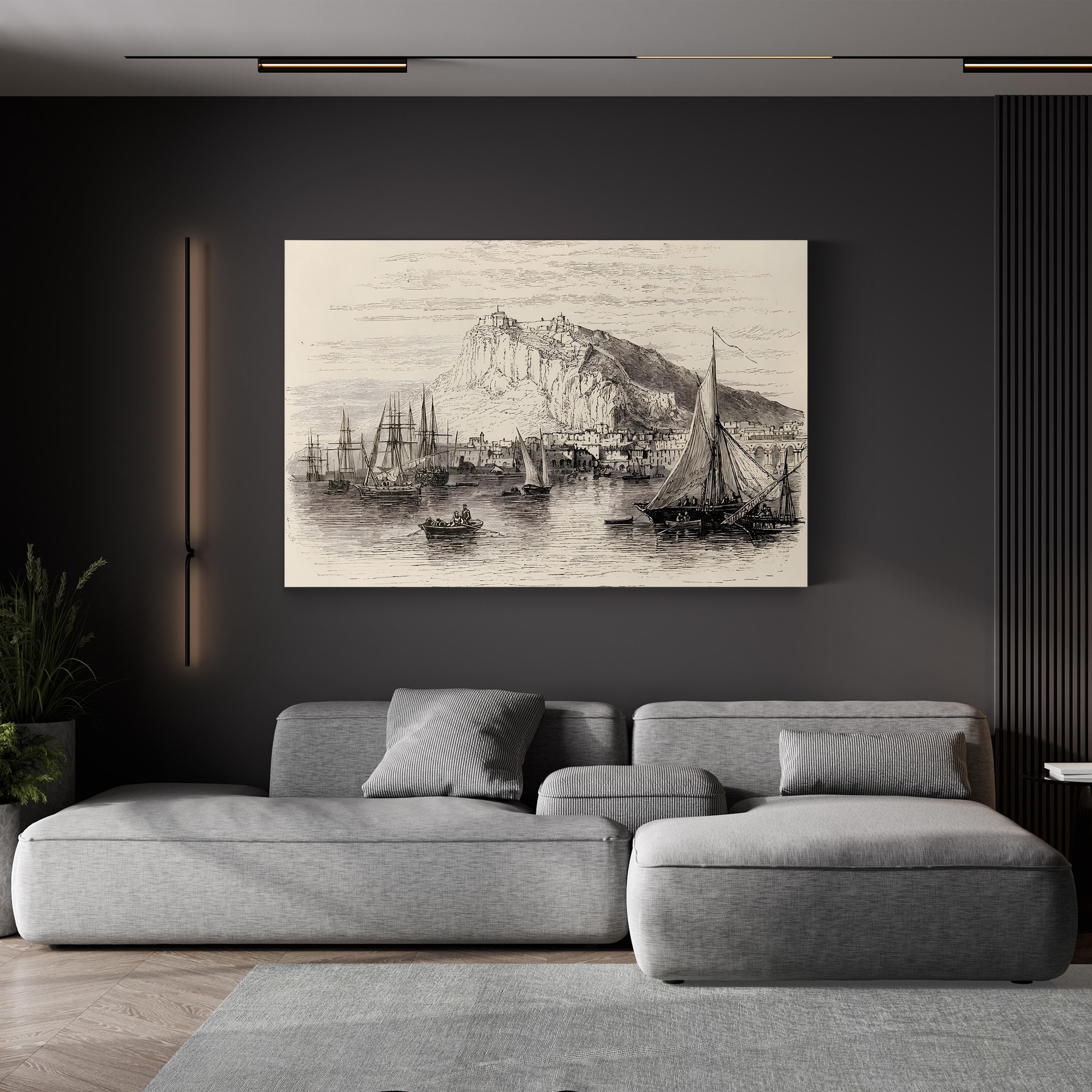 Gray sectional sofa in a living room with a large wall art piece depicting a coastal scene.