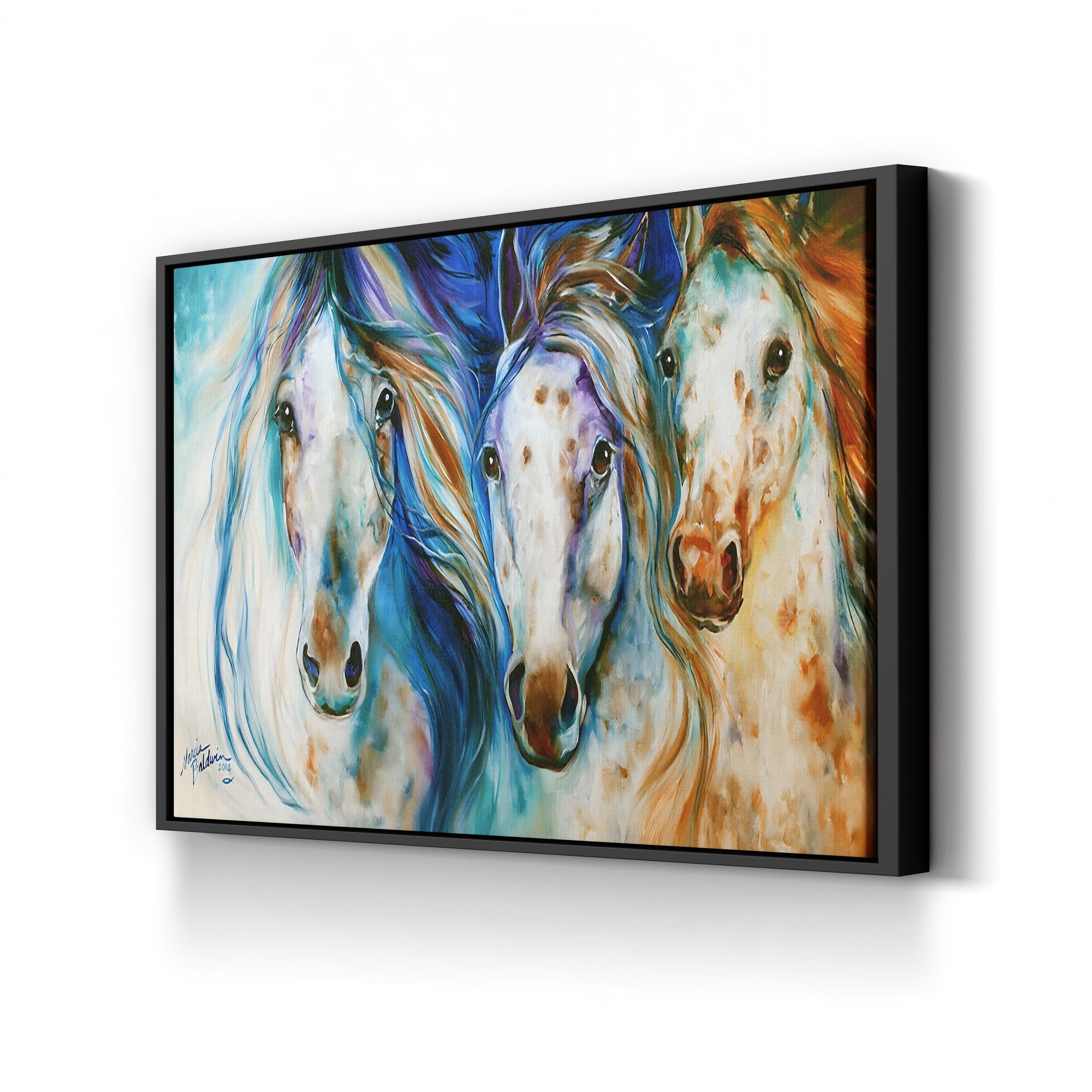 Framed artwork of three colorful horses on a white wall