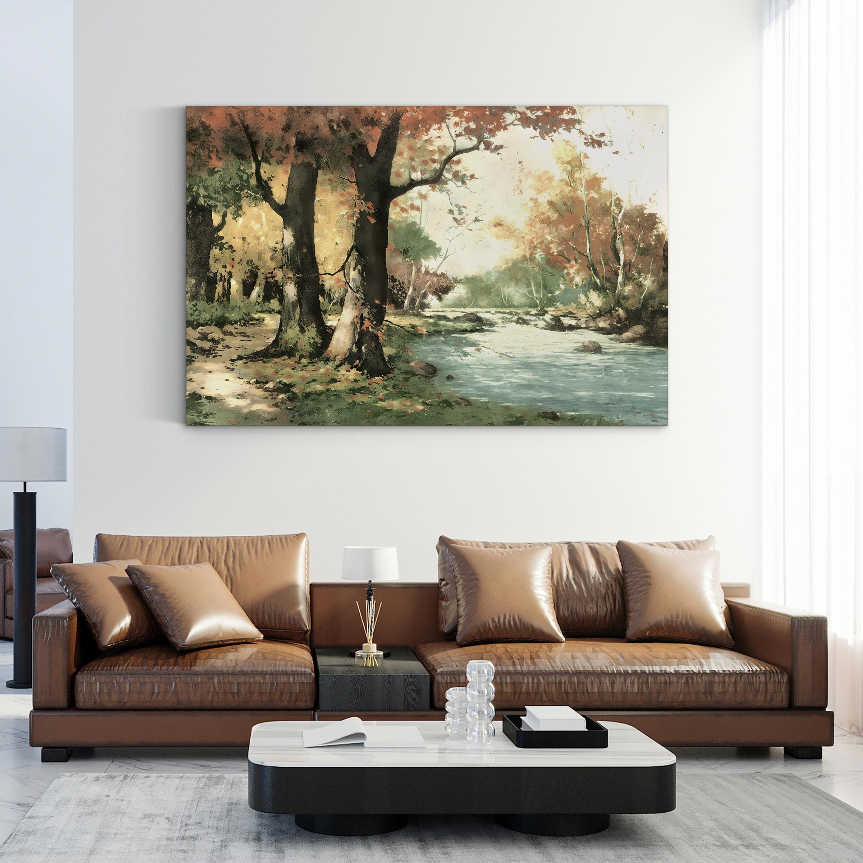 Brown leather sofa in a living room with a nature-themed painting on the wall.