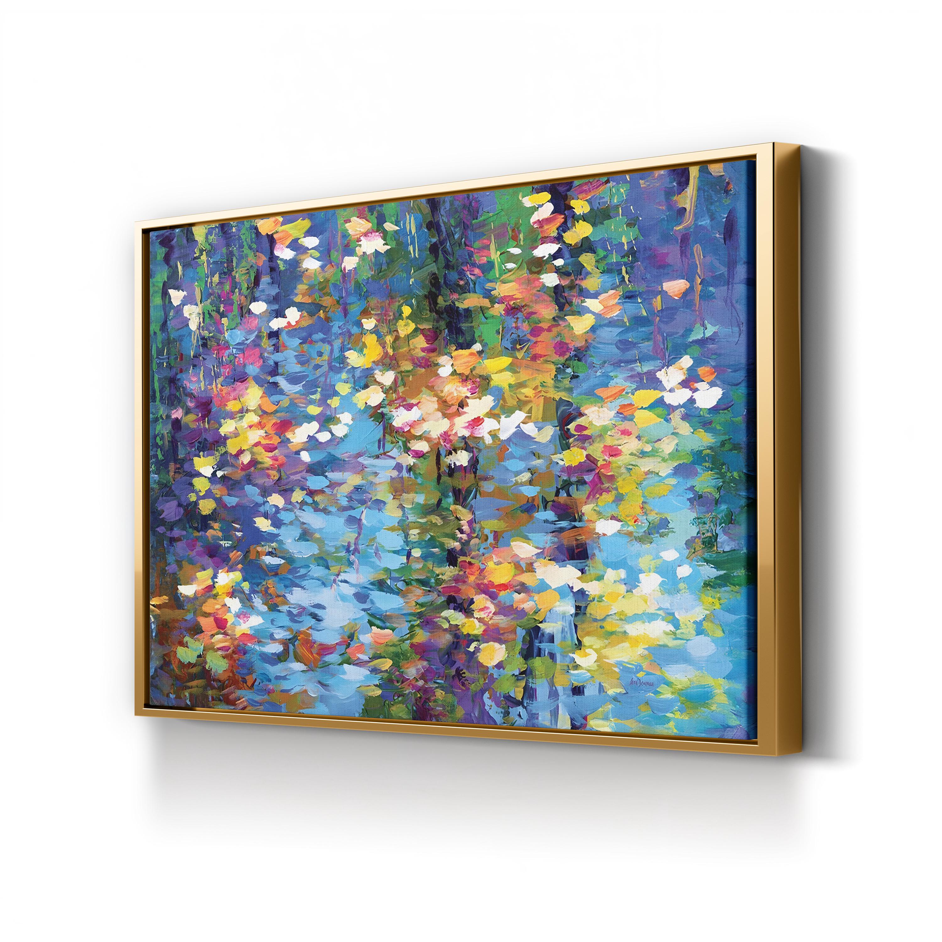 Colorful abstract painting in a gold frame on a white wall