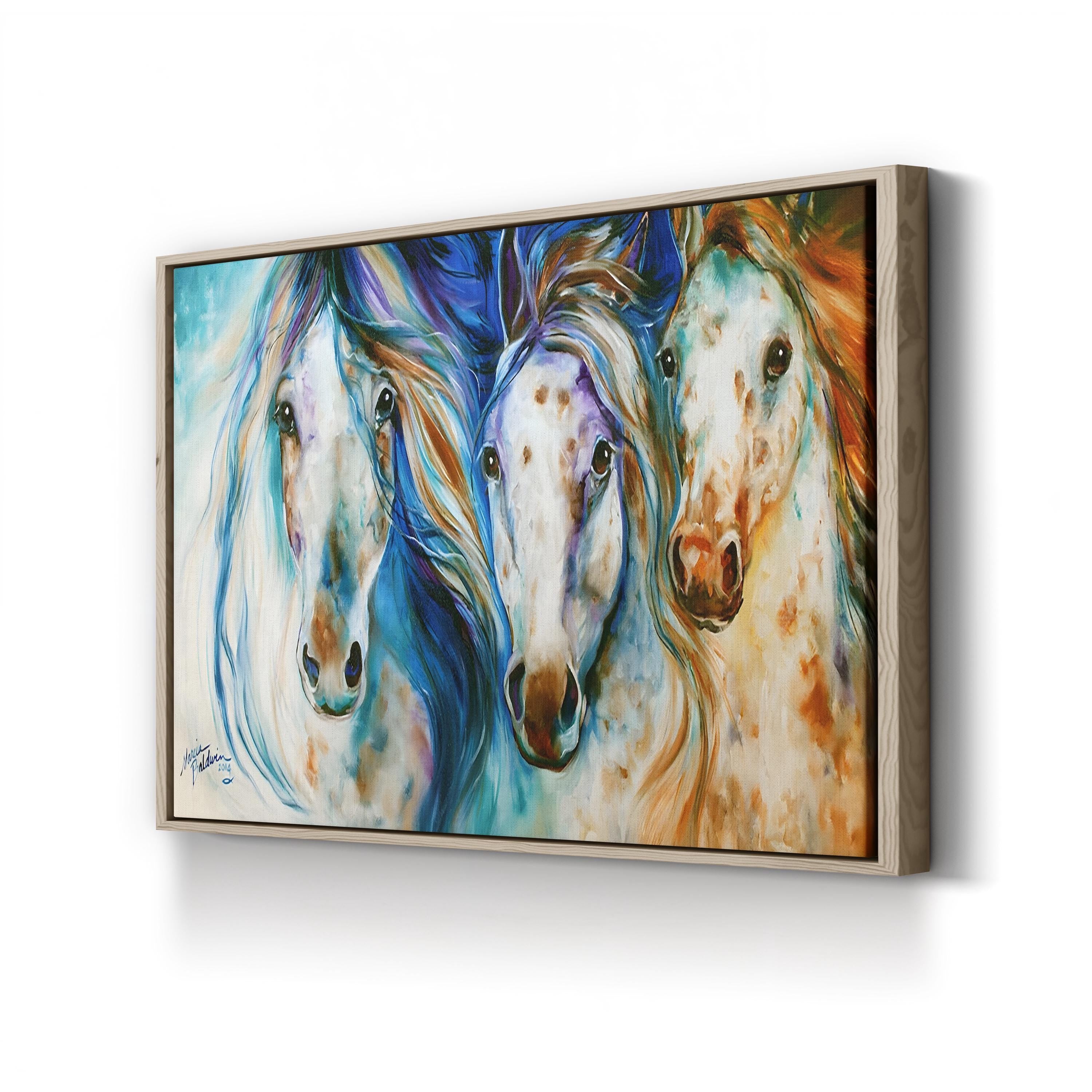 Framed artwork of three colorful horses on a white wall