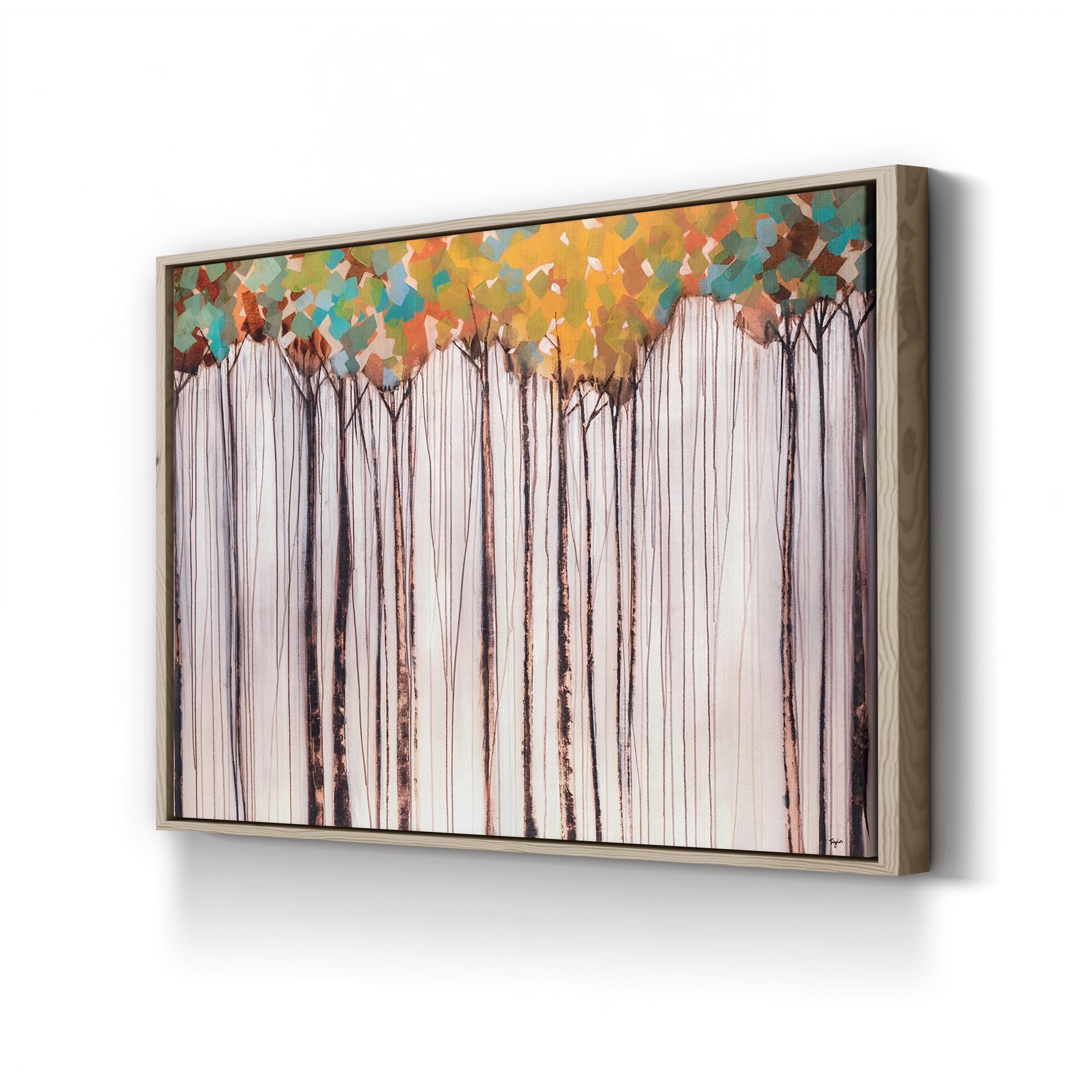 Framed artwork of trees with colorful foliage on a white wall